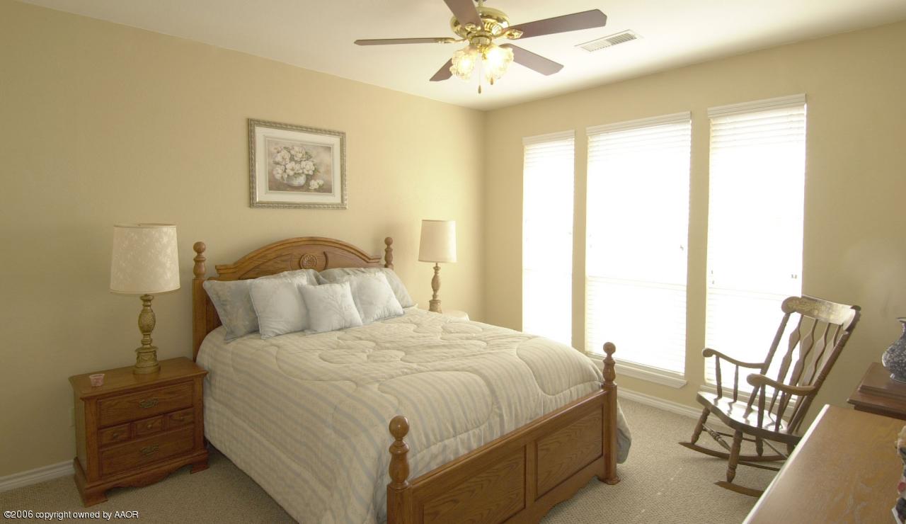 8800 Red Wing Road Amarillo, TX 79119 - Photo 8 of 15 a bedroom with a bed and chair
