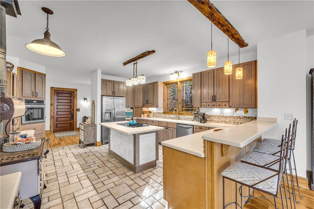 740 Little Rock Creek Road Cherry Log, GA 30522 - Photo 23 of 98 a room with stainless steel appliances kitchen island granite countertop a sink and a refrigerator