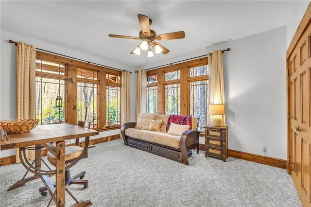 a bedroom with a bed and a large window