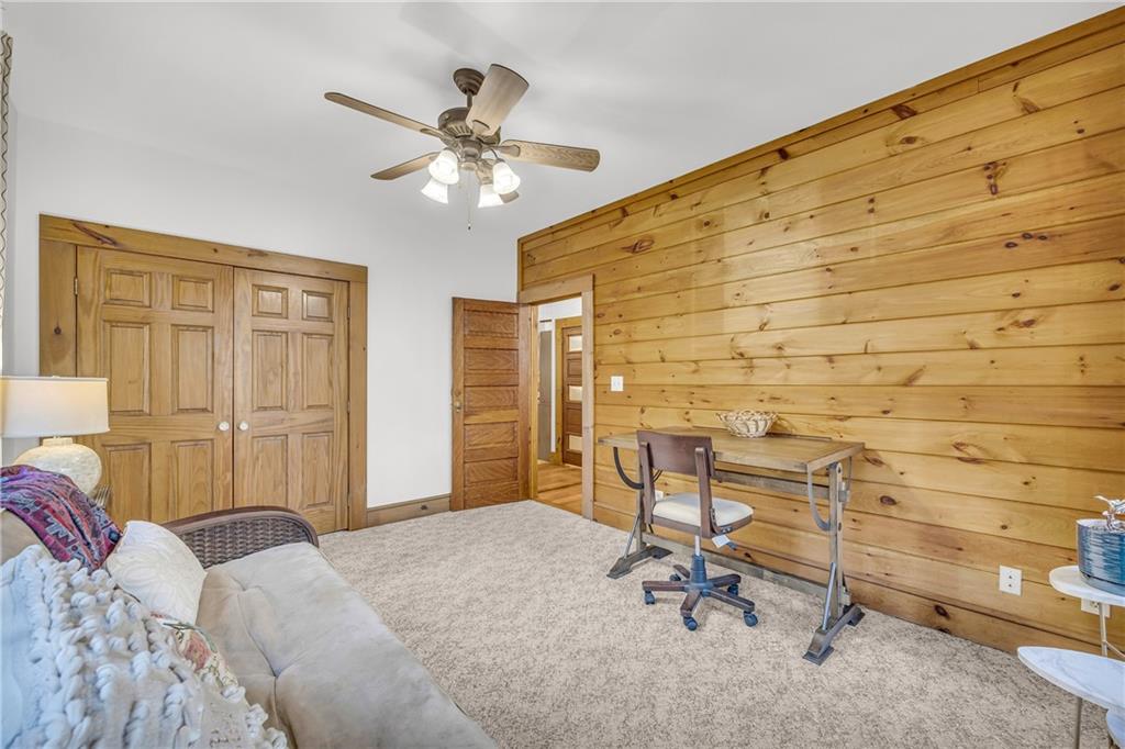 740 Little Rock Creek Road Cherry Log, GA 30522 - Photo 36 of 98 a bedroom with a chair and a chandelier