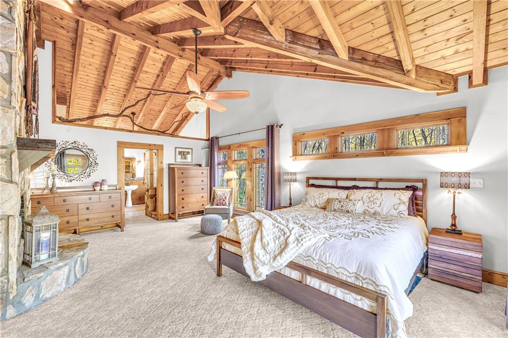 740 Little Rock Creek Road Cherry Log, GA 30522 - Photo 45 of 98 a large bedroom with a bed a couch and dresser next to a window