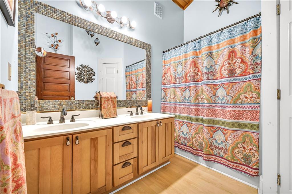 740 Little Rock Creek Road Cherry Log, GA 30522 - Photo 60 of 98 a bathroom with a sink a mirror and a shower curtain