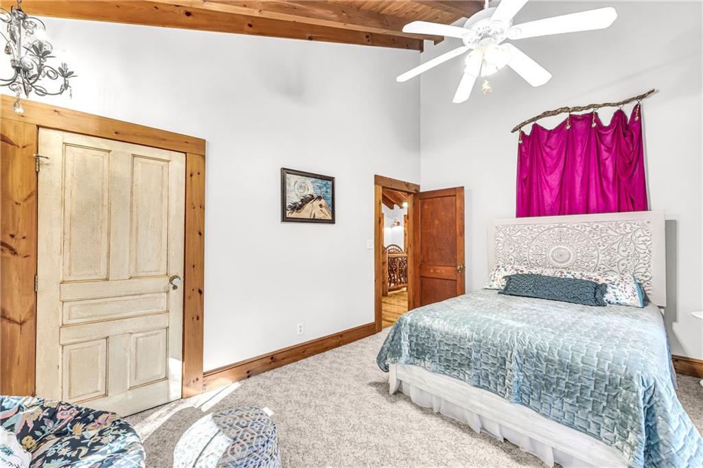 740 Little Rock Creek Road Cherry Log, GA 30522 - Photo 62 of 98 a bedroom with a bed and a chandelier