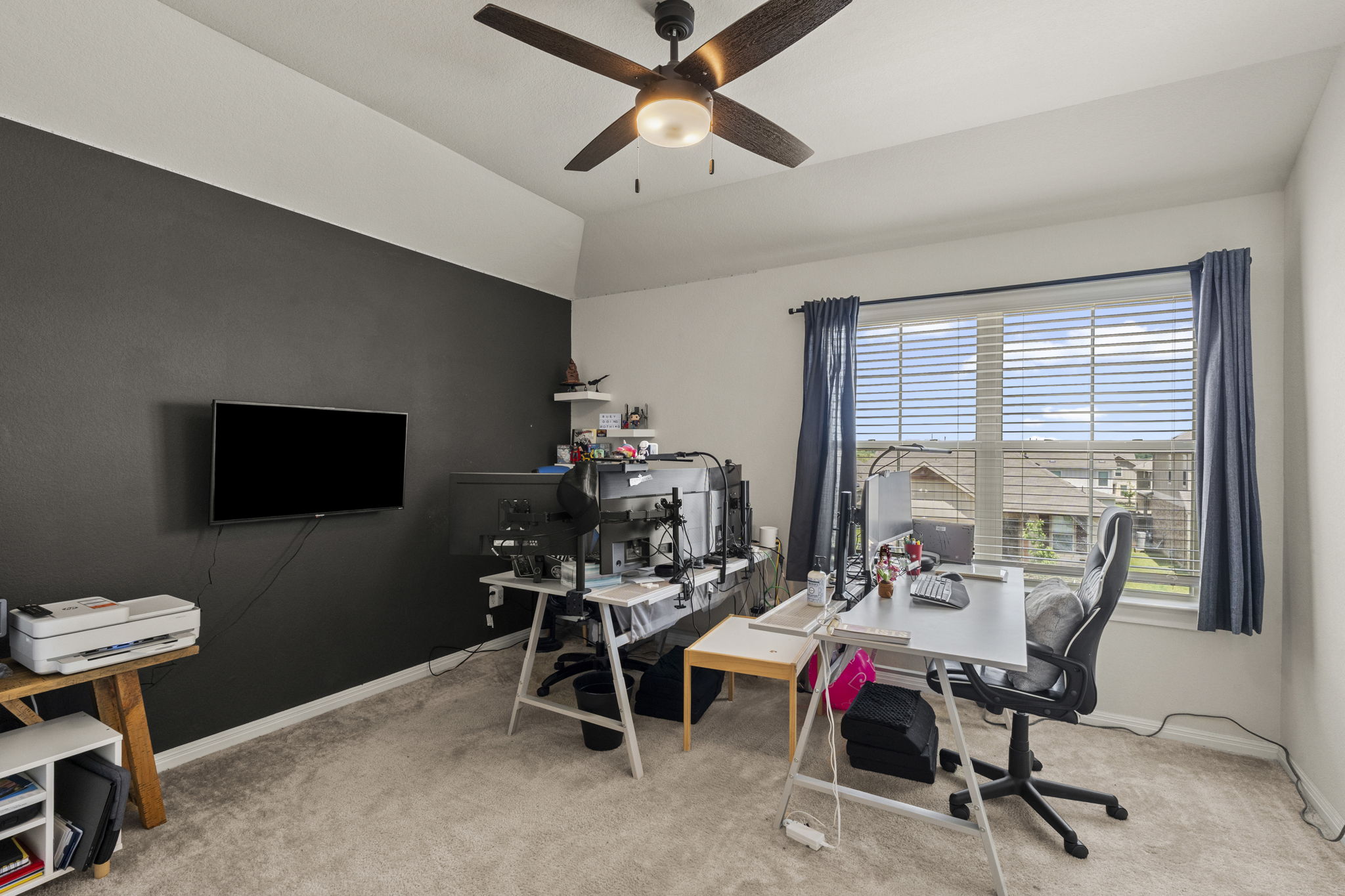 548 Purple Heart Drive Buda, TX 78610 - Photo 18 of 35 A dedicated home office space with textured walls and an overhead ceiling fan for optimal comfort.