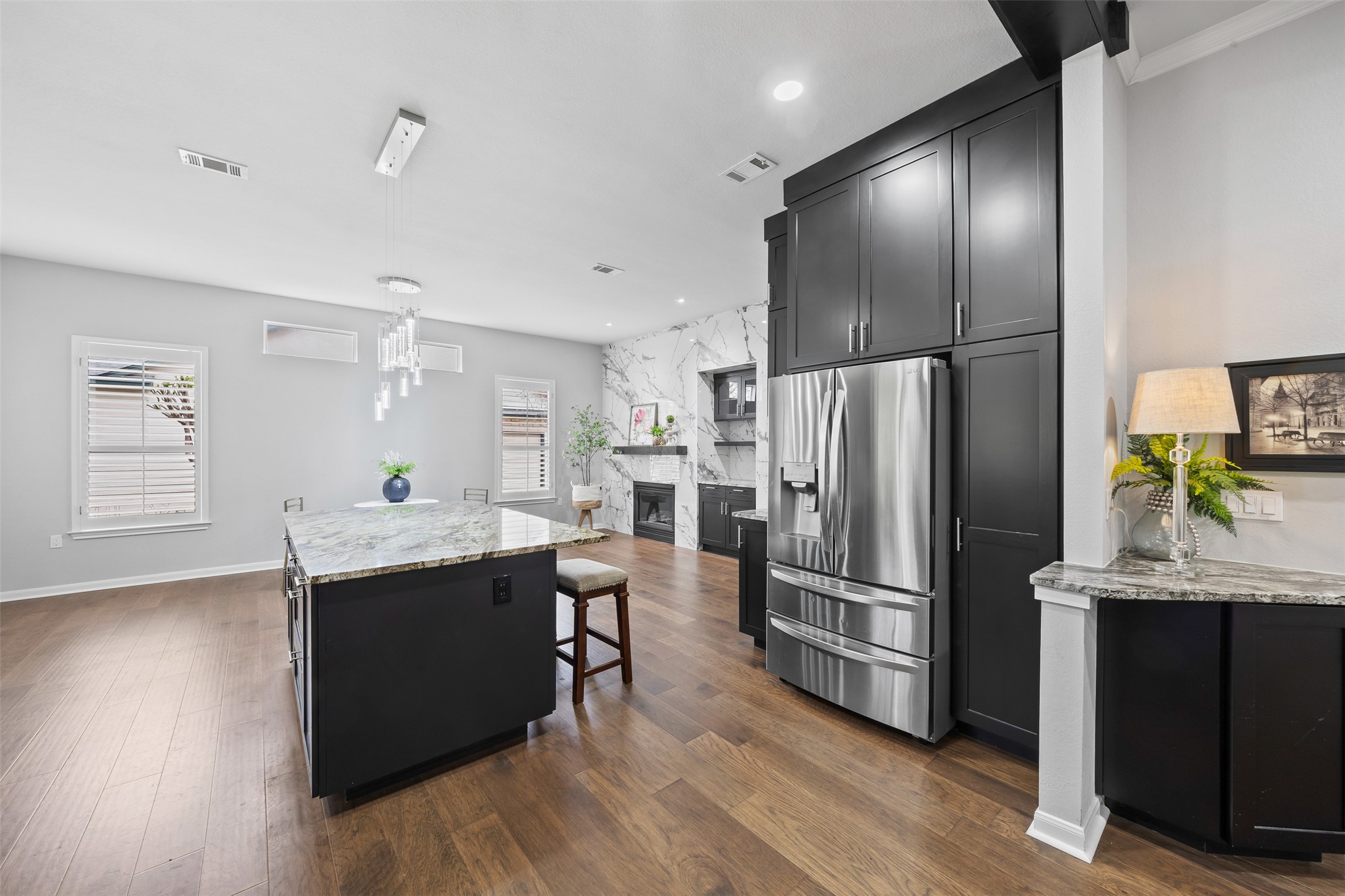 144 Stetson Trail Georgetown, TX 78633 - Photo 13 of 39 Kitchen with decorative light fixture and a high end fireplace