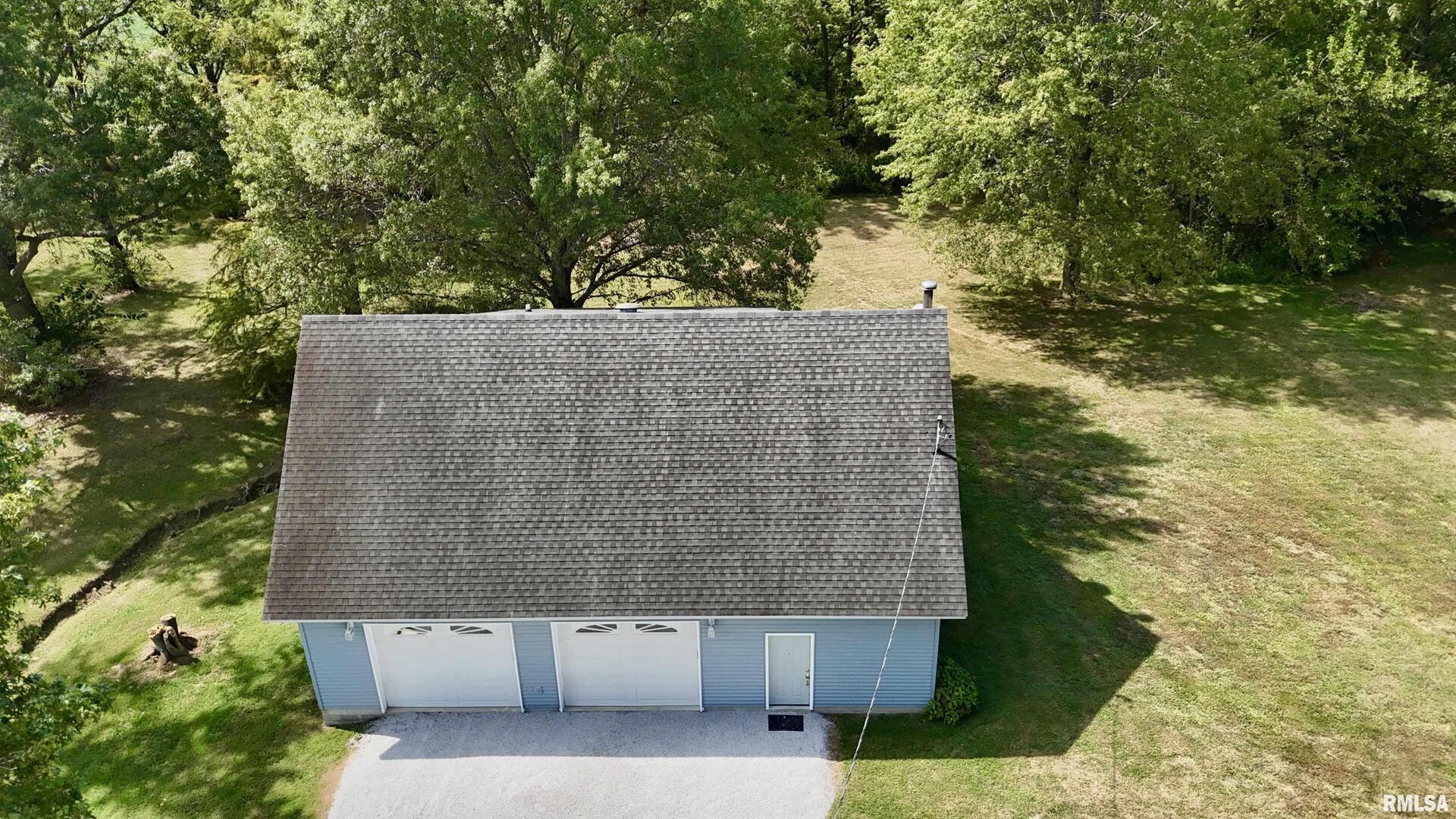 a aerial view of a house with a yard