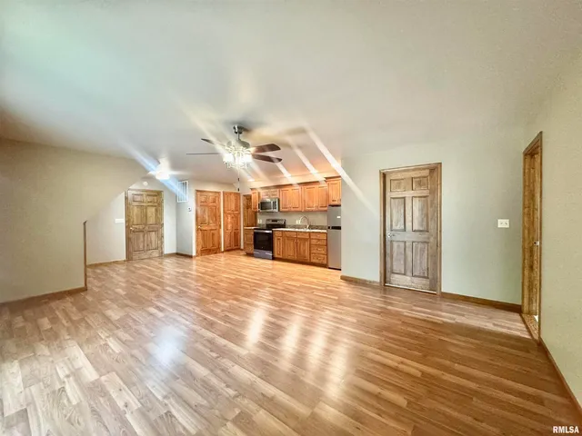 a view of empty room with wooden floor