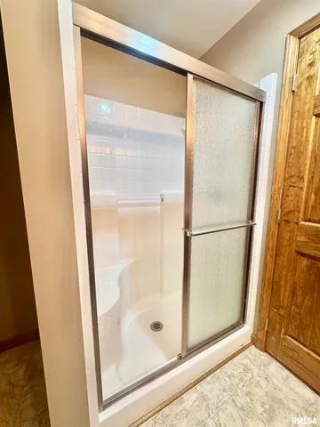 a bathroom with a glass shower door
