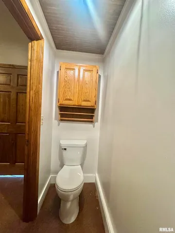 a bathroom with a toilet a sink and a window