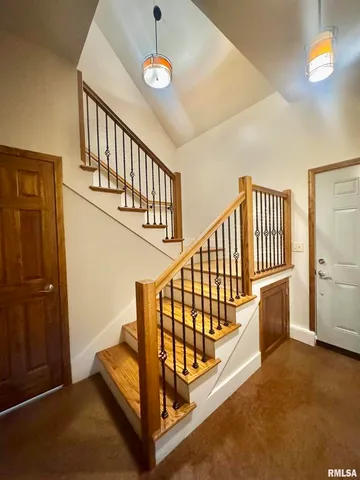 a view of staircase with lots of frames on the wall