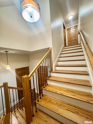 a view of staircase with wooden floor