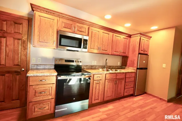 a kitchen with stainless steel appliances granite countertop a stove and a microwave