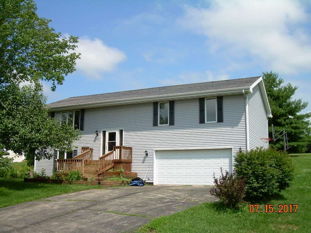 2276 Drexel Road Davis, IL 61019 - Photo 1 of 17 a front view of a house with a yard and garage