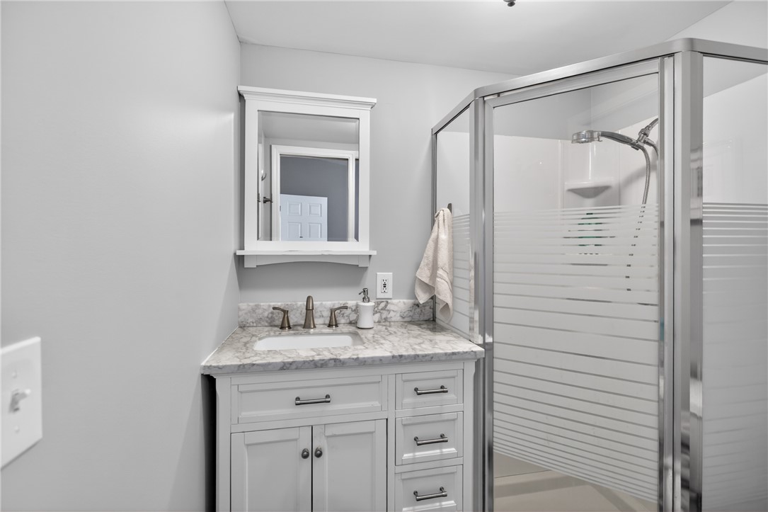 1230 Melton Road, Unit 4 West Union, SC 29696 - Photo 20 of 48 A well-appointed bath features a marble-topped vanity and a glass-enclosed shower.