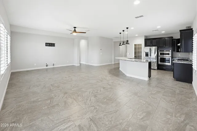 a bedroom with a bed a chandelier and a window