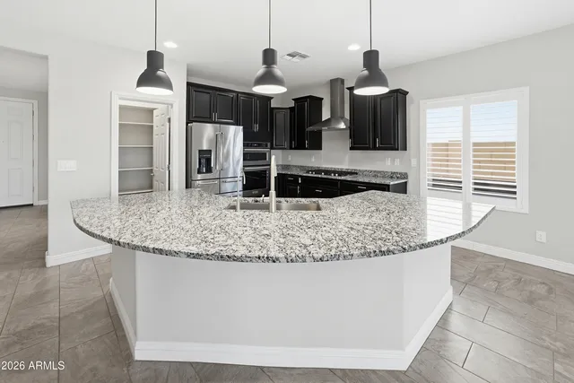 a bathroom with a granite countertop sink double vanity and a mirror