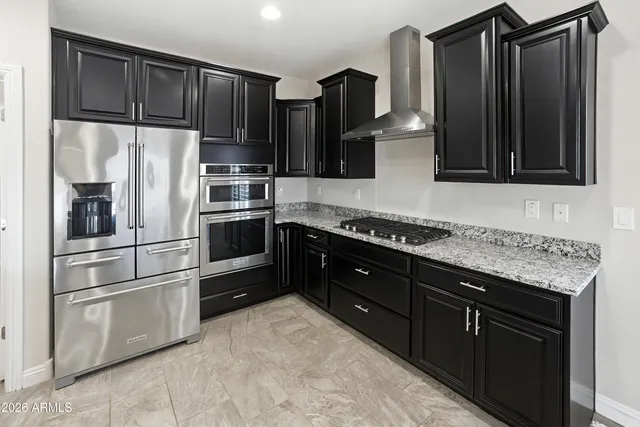 a spacious bathroom with a granite countertop sink a mirror a shower and a glass door