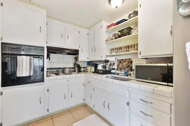 a kitchen with stainless steel appliances cabinets and a counter top space