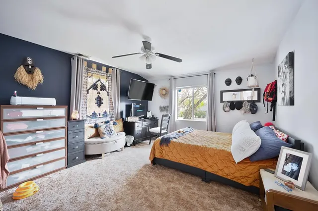 a bedroom with bed and a window