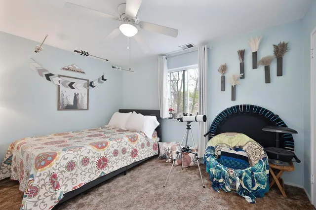 a bedroom with a bed and a mirror