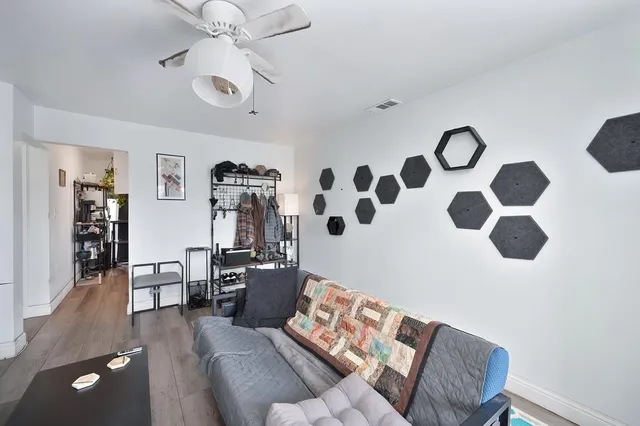 a living room with furniture and wooden floor