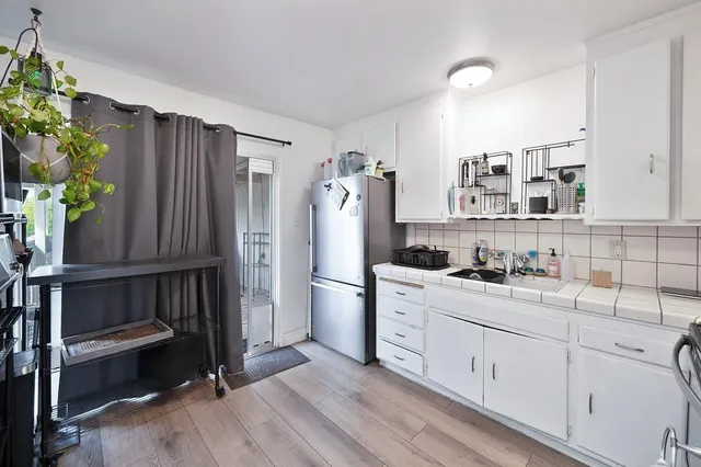 a kitchen with a sink stainless steel appliances and cabinets