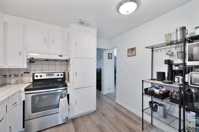 a kitchen with cabinets and appliances