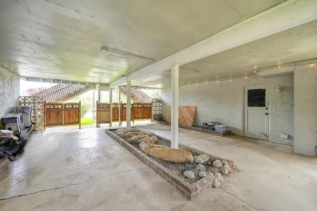 a view of a hall with the view of living room