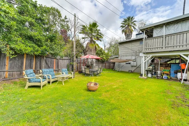 a view of a patio with table and chairs and potted plants