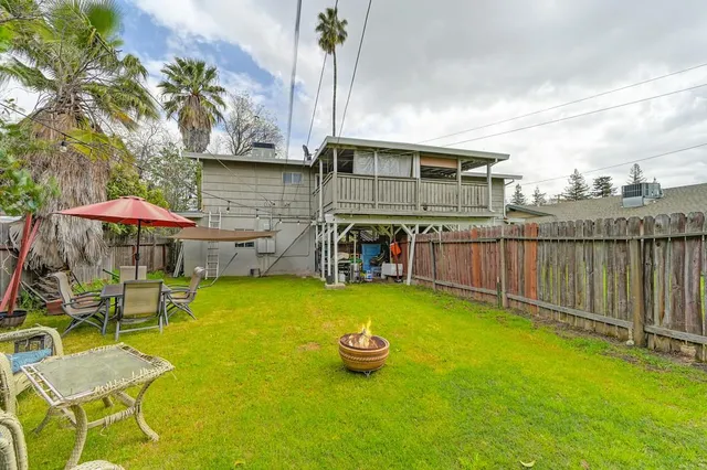 a view of swimming pool with table and chairs under an umbrella