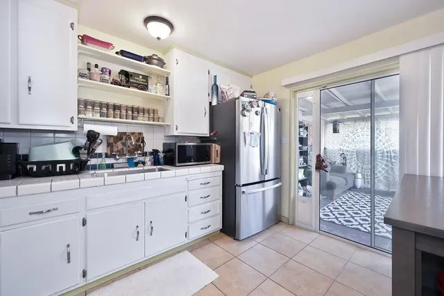 a kitchen with stainless steel appliances a refrigerator sink and cabinets