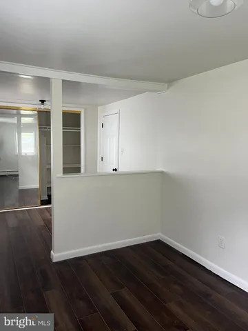 a view of an empty room and wooden floor