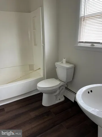 a bathroom with a toilet and a bathtub