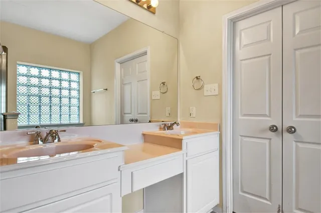 a bathroom with a tub sink and mirror