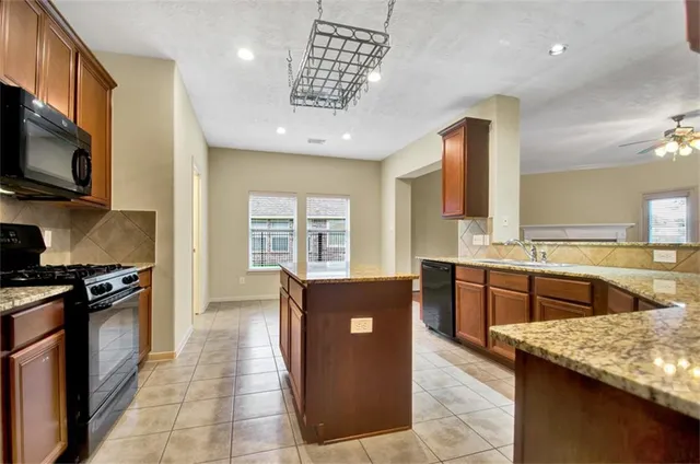 a kitchen with stainless steel appliances granite countertop a stove and a sink