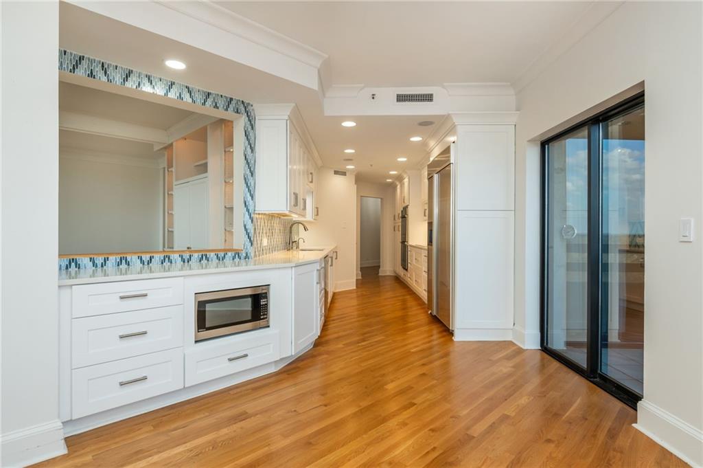 2660 Peachtree Road Northwest, Unit 22E Atlanta, GA 30305 - Photo 12 of 48 a bathroom with a sink a vanity and a mirror