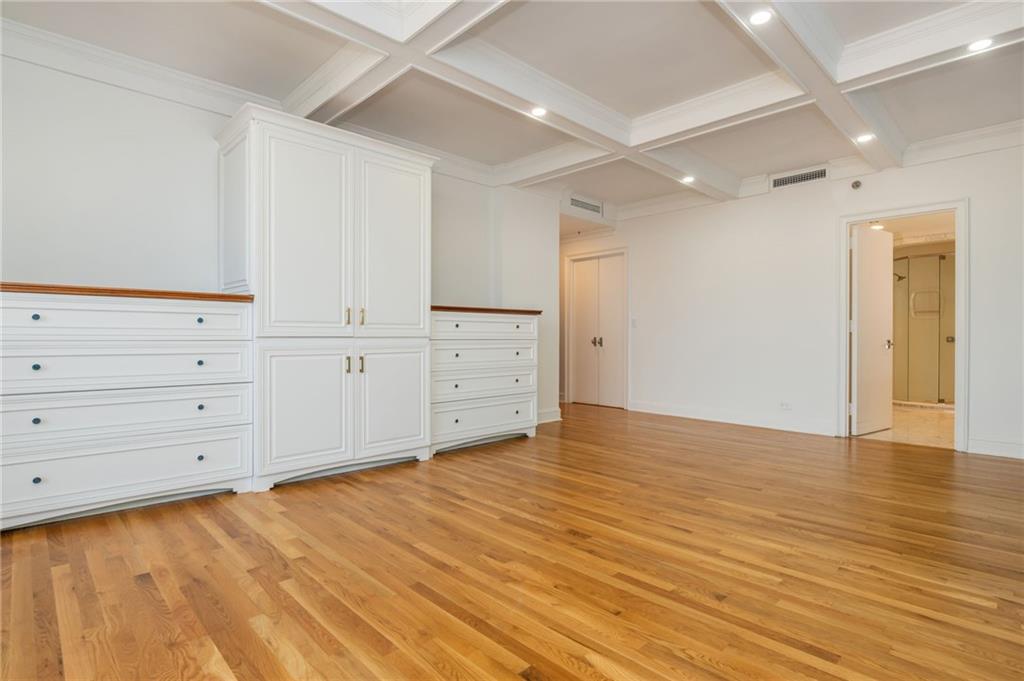 2660 Peachtree Road Northwest, Unit 22E Atlanta, GA 30305 - Photo 15 of 48 a view of an empty room with wooden floor
