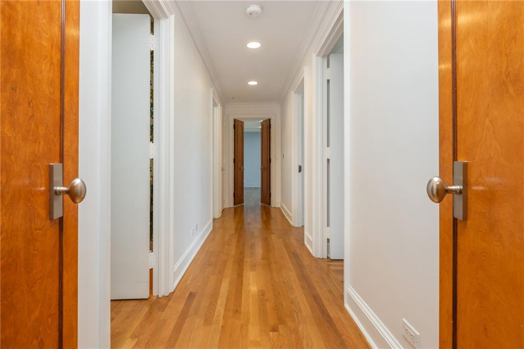 2660 Peachtree Road Northwest, Unit 22E Atlanta, GA 30305 - Photo 15 of 52 a view of a hallway with wooden floor and staircase