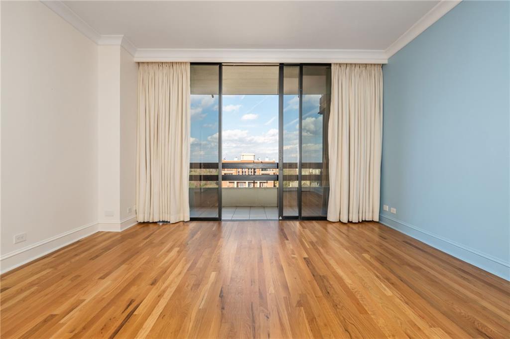 2660 Peachtree Road Northwest, Unit 22E Atlanta, GA 30305 - Photo 18 of 48 wooden floor in an empty room with a window