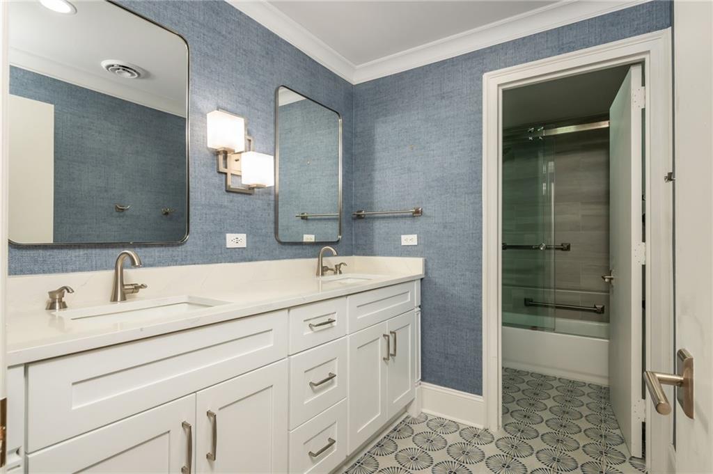2660 Peachtree Road Northwest, Unit 22E Atlanta, GA 30305 - Photo 21 of 48 a bathroom with double sink and a mirror