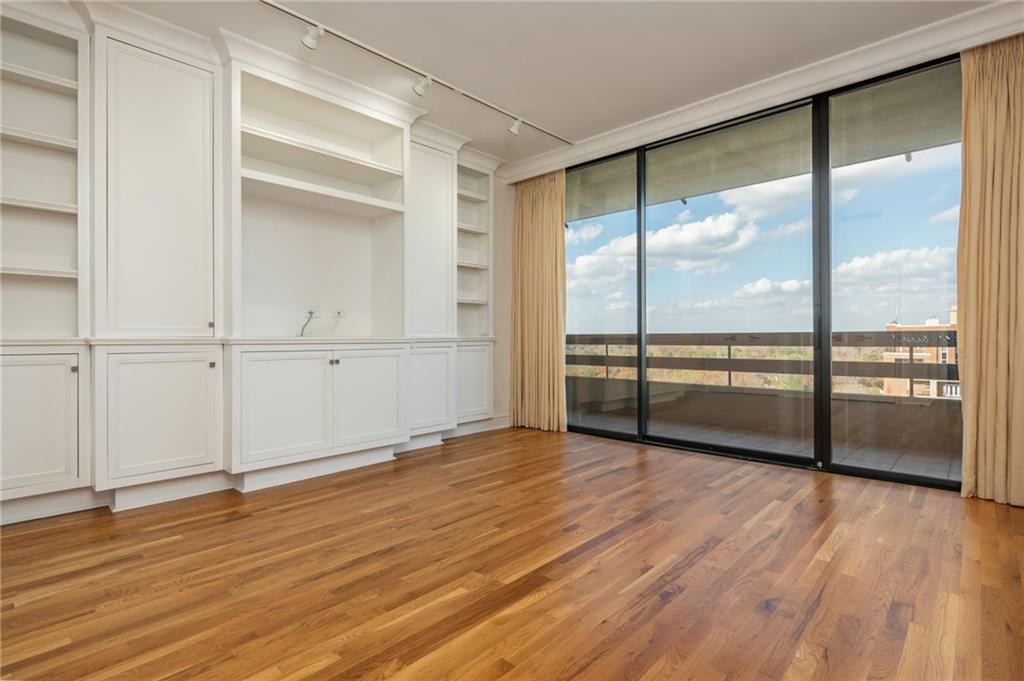 2660 Peachtree Road Northwest, Unit 22E Atlanta, GA 30305 - Photo 23 of 48 a view of an empty room with wooden floor and a window