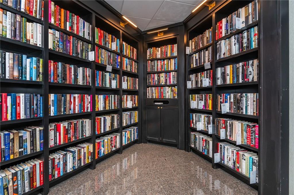 2660 Peachtree Road Northwest, Unit 22E Atlanta, GA 30305 - Photo 31 of 48 a view of room with lots of book shelf