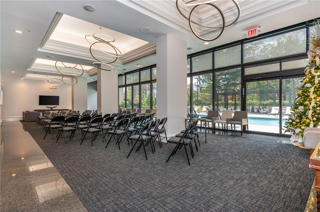 2660 Peachtree Road Northwest, Unit 22E Atlanta, GA 30305 - Photo 37 of 48 a dining hall with lots of tables a large window and chairs