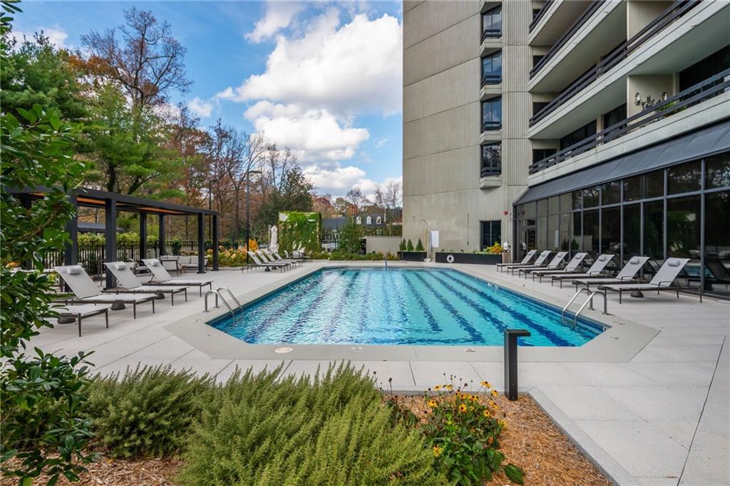 2660 Peachtree Road Northwest, Unit 22E Atlanta, GA 30305 - Photo 44 of 52 a view of swimming pool with outdoor seating and plants