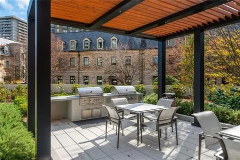 a view of a patio with chairs and a flower pot