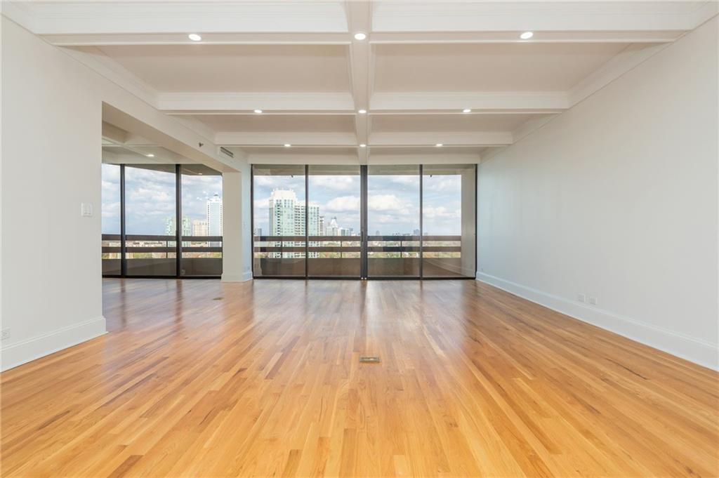 2660 Peachtree Road Northwest, Unit 22E Atlanta, GA 30305 - Photo 5 of 48 wooden floor in an empty room with a window