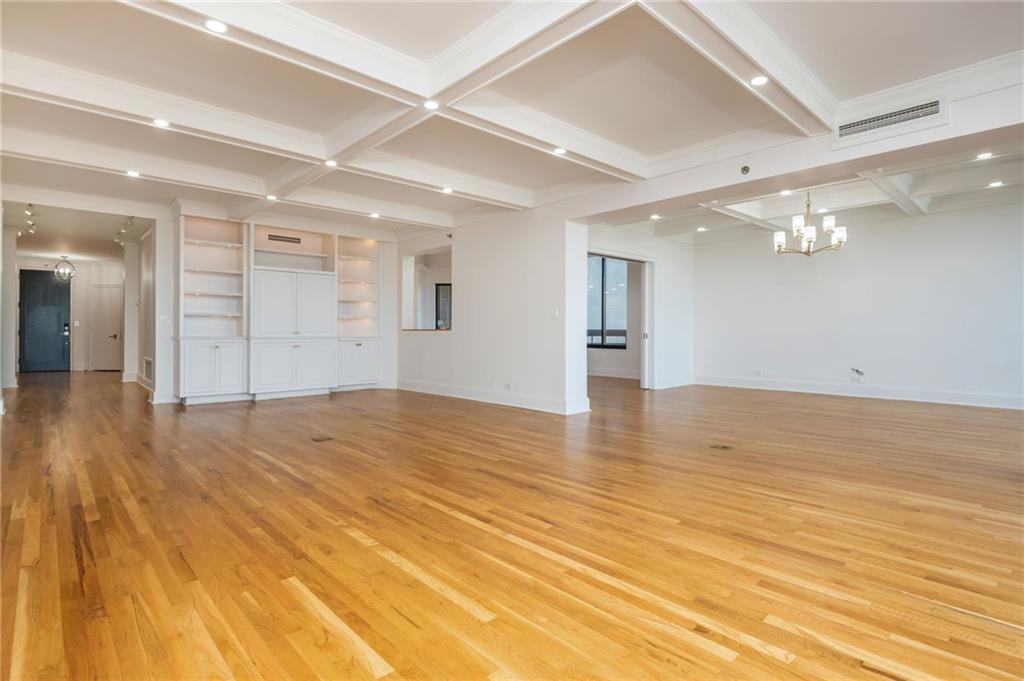 2660 Peachtree Road Northwest, Unit 22E Atlanta, GA 30305 - Photo 8 of 48 an empty room with wooden floor