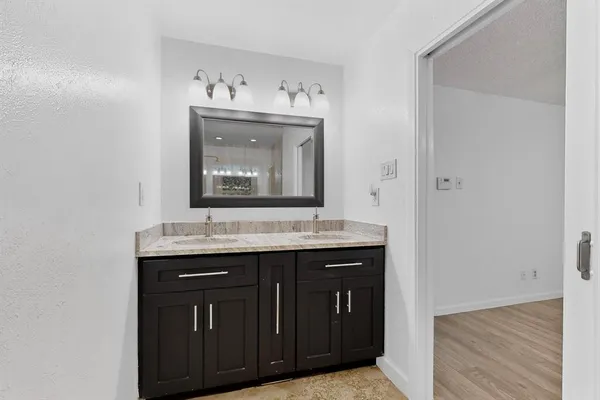a bathroom with a sink vanity and mirror