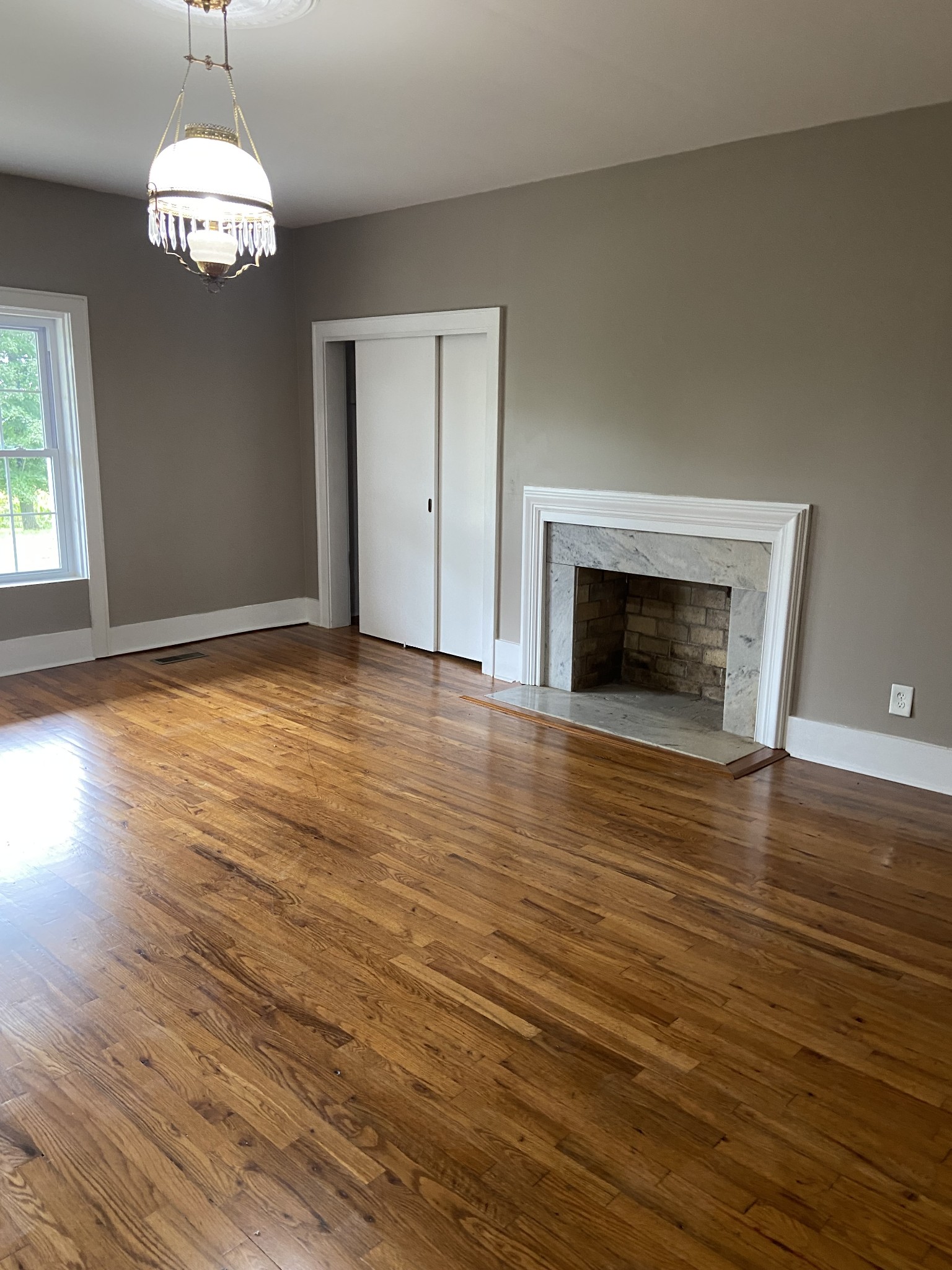 11495 Guthrie Road Guthrie, KY 42234 - Photo 23 of 43 a view of an empty room with wooden floor fireplace and a window
