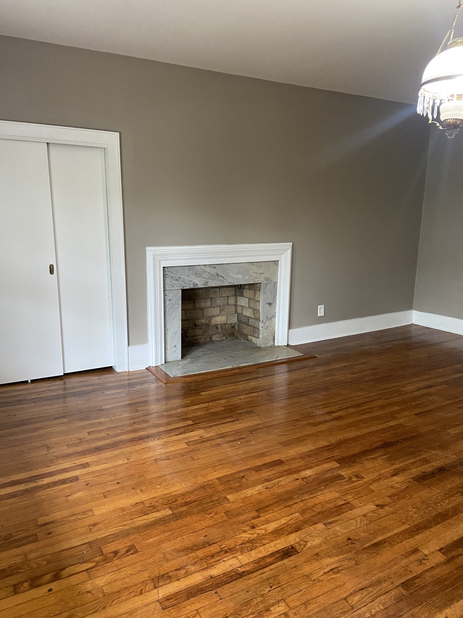 11495 Guthrie Road Guthrie, KY 42234 - Photo 26 of 43 a view of empty room with wooden floor and fireplace
